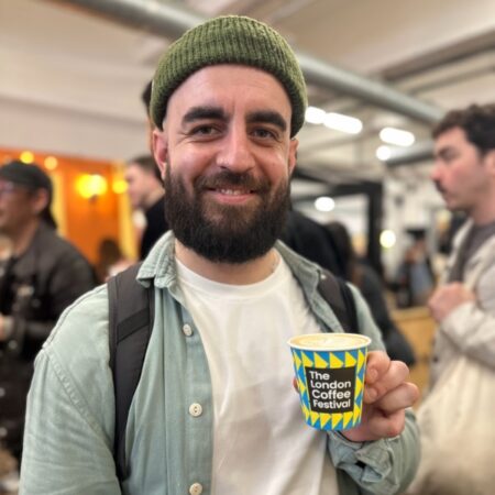 Matthew Algie employee holding coffee cup at the London Coffee Festival